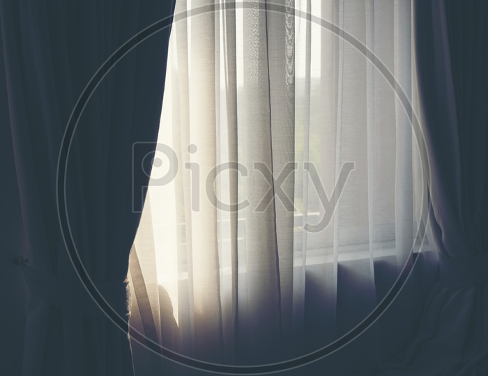 White curtains in a warm bedroom Window