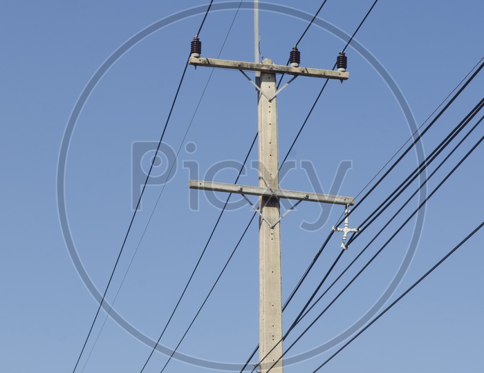 Electricity Wires With Poles Over Blue Sky