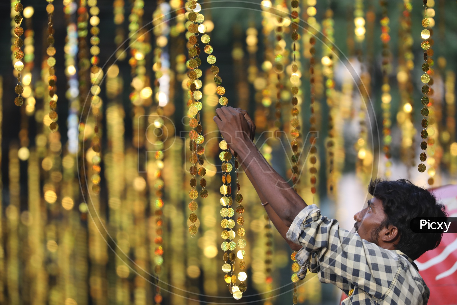 Indian Man arranging the hanging decorations