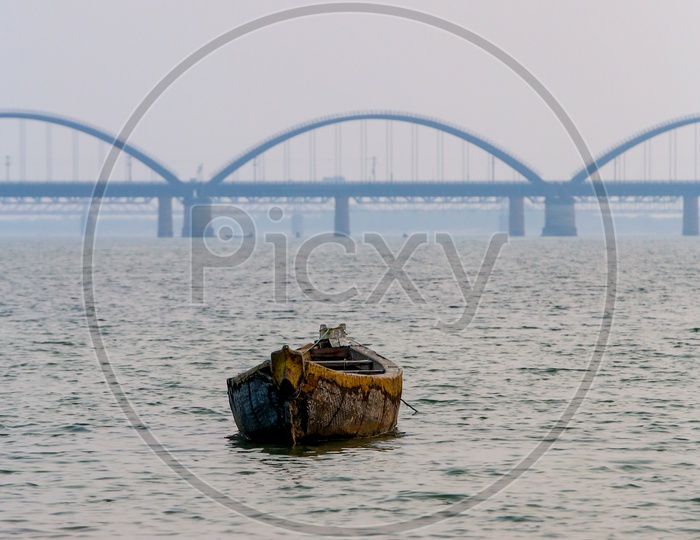 Fishing Boats on Godavari River With Arch Bridge in Background