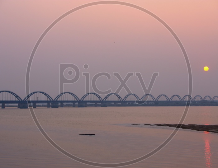 Rajahmundry Arch Bridge With Sunset Bright Round Sun in Sky
