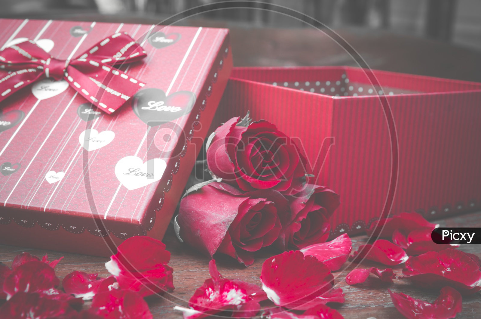 Red Roses And Gift Box Over a Wooden Background Forming Templates For Valentine's Day Or Lovers Day