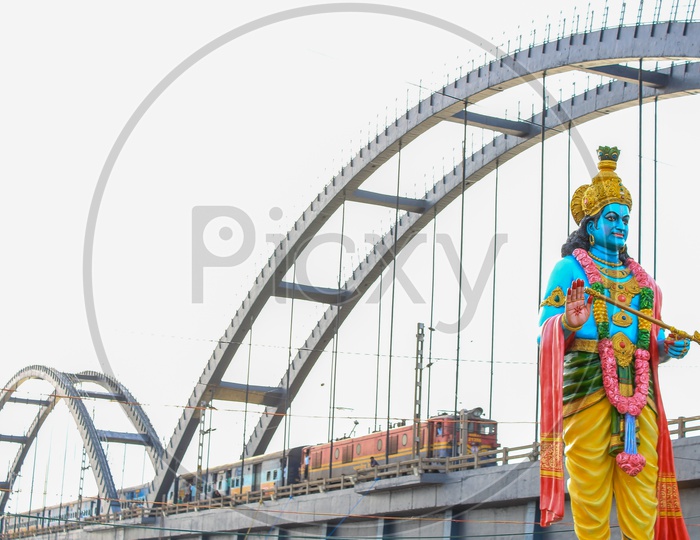 Lord Krishna Statue With  Train on Arch Bridge  At Rajahmundry  Over Godavari River