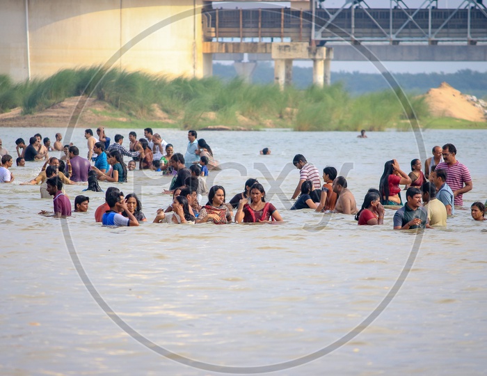 Indian Hindu Devotees Taking Holy Bath in Godavari River During Godavari Pushkaralu  in Rajahmundry