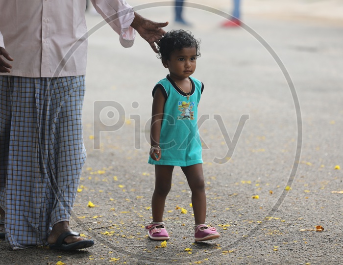 Indian Little girl walking on the road