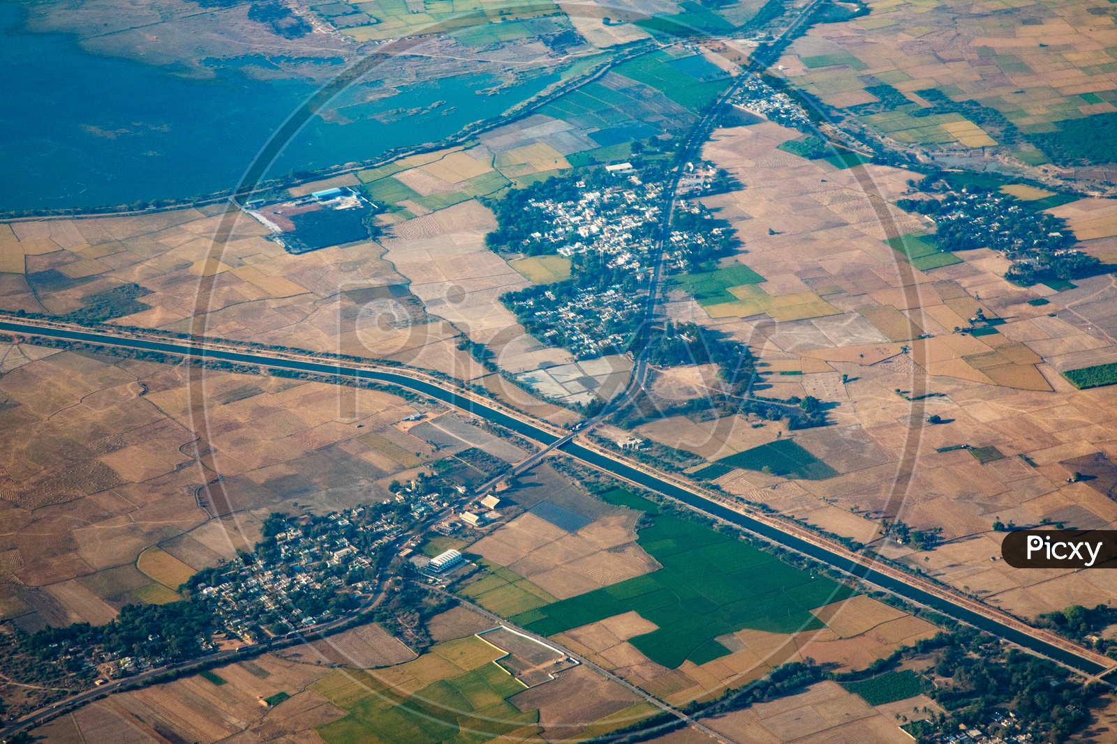 Aerial View Of Green Paddy Fields And  Roads  From Flight Window