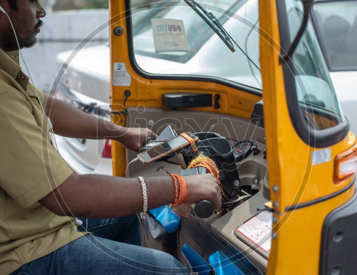 Auto Driver Riding Auto By Putting On Earphones