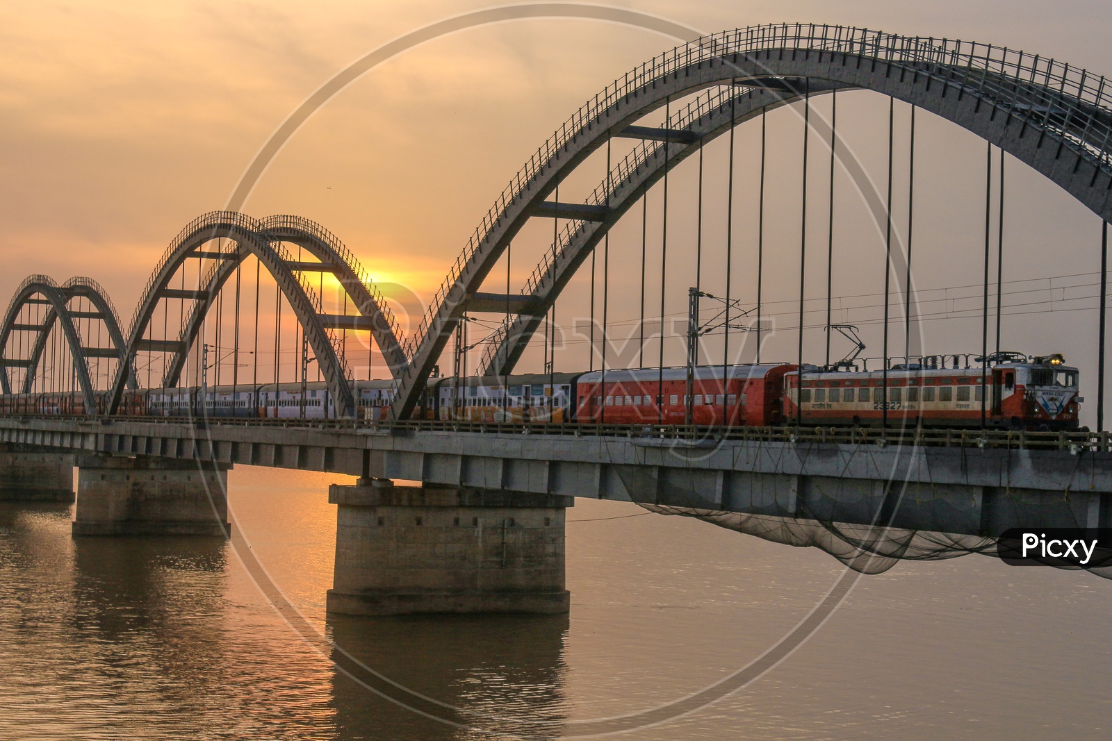 Rajahmundry Arch Bridge With Train On It with Sunset Sky In Background