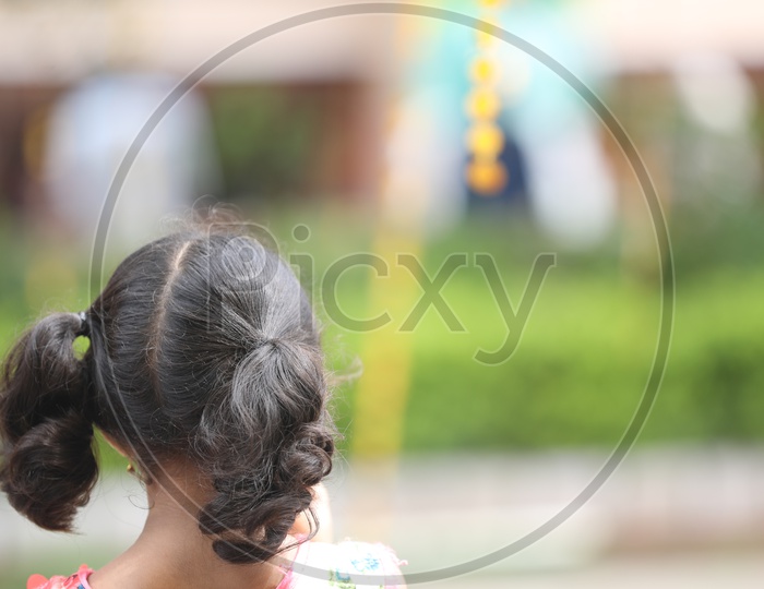 Indian girl with pig tails hairstyle