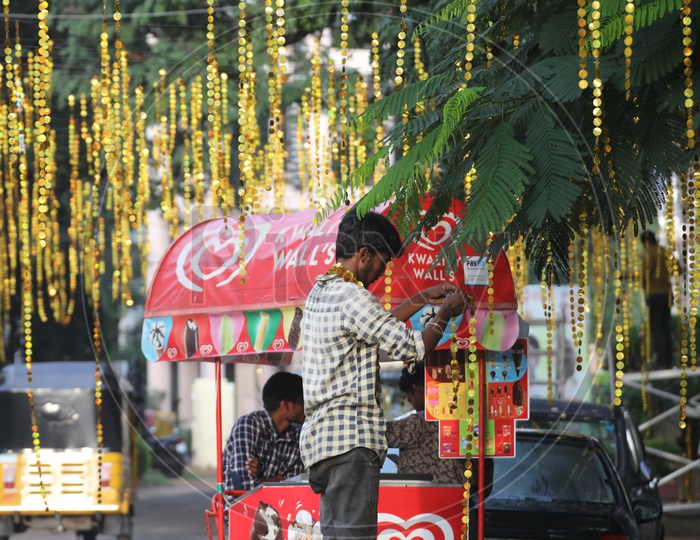 An Indian man setting up the decorations