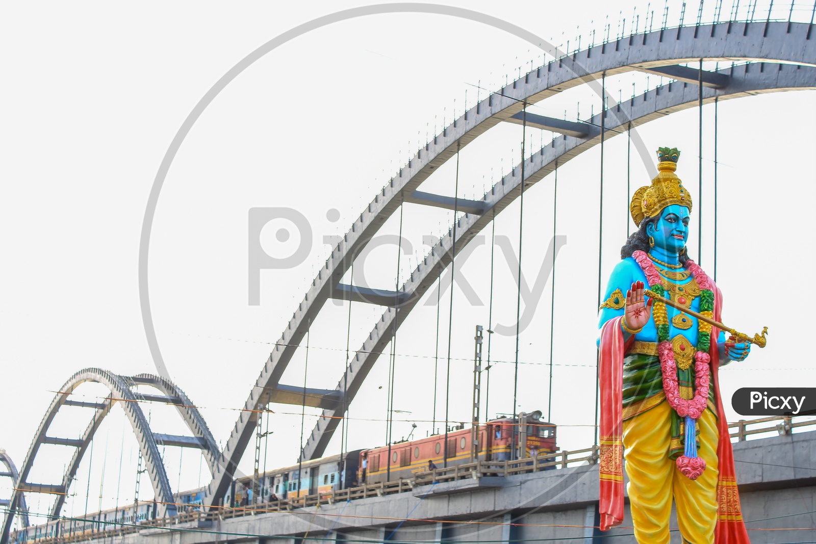 Lord Krishna Statue With  Train on Arch Bridge  At Rajahmundry  Over Godavari River