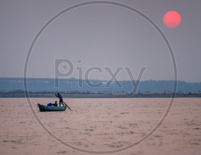 Sunset Bright Round Sun With Fisherman Boat On Godavari River