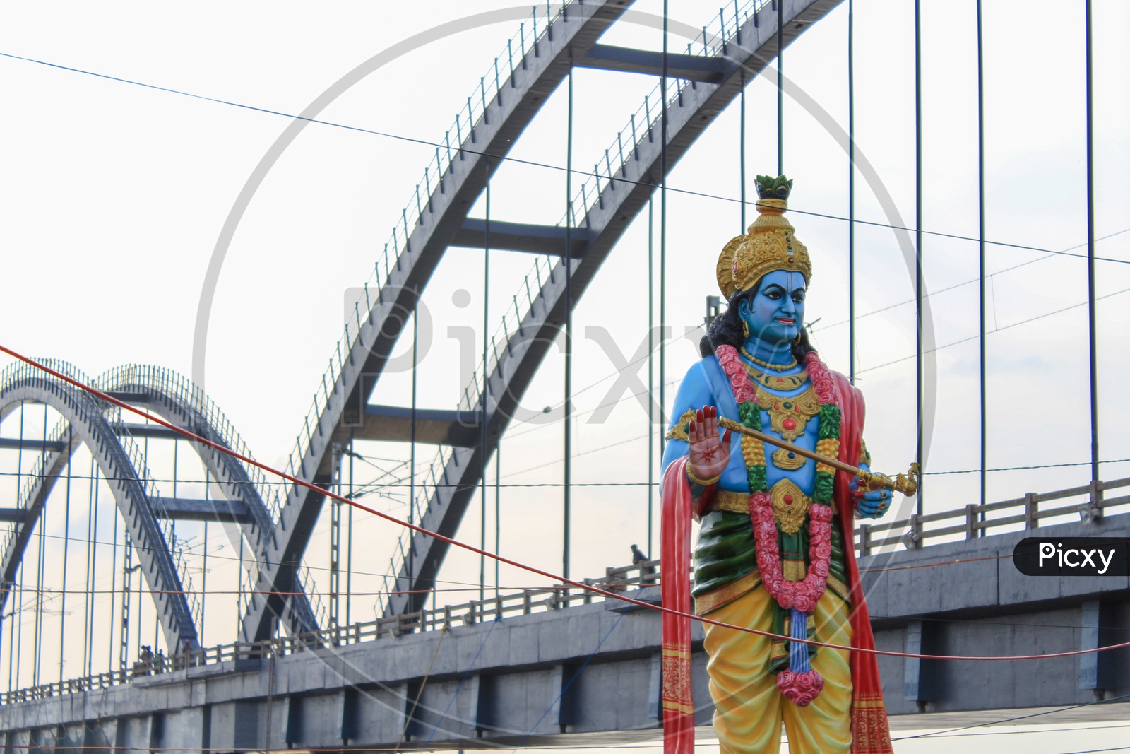 Lord Krishna Statue With Godavari Arch Bridge In Background