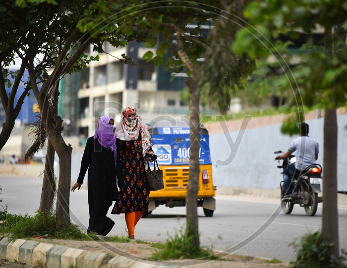 Woman Pedestrians or   Employees Wearing Scarfs  For Pollution on Hyderabad City Roads