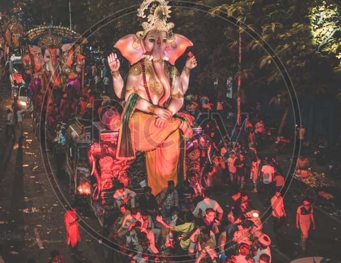 People dancing in front of huge ganesh idol
