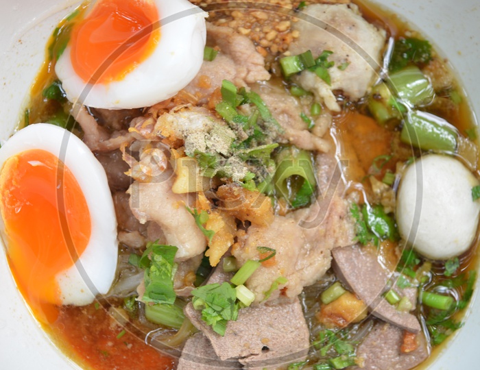 closeup of Bowl With Thai pork Noodles and  Boiled egg