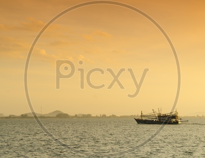 Steamer Boat At A Shore With Sunset Luminous Light