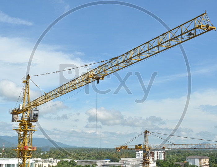 Heavy Crane and building working progress at a construction site