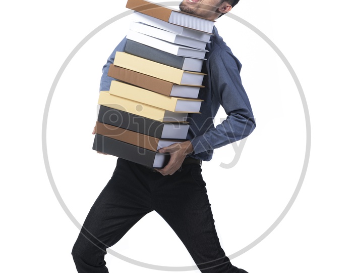Full length portrait of a professional man carrying heavy folders of book, isolated on white background