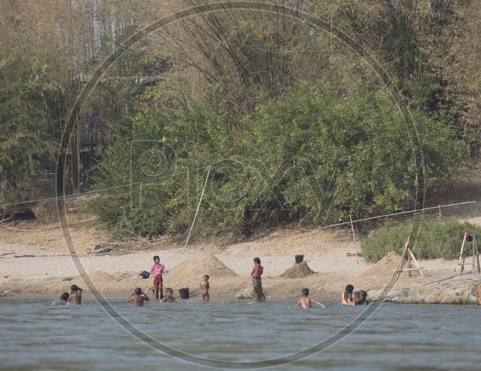 Children  Taking Bath In Mekong River Bank