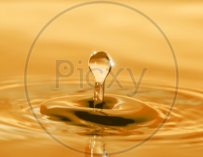 Water Splash With Droplet Macro  Closeup With Luminous Golden Colour Filter