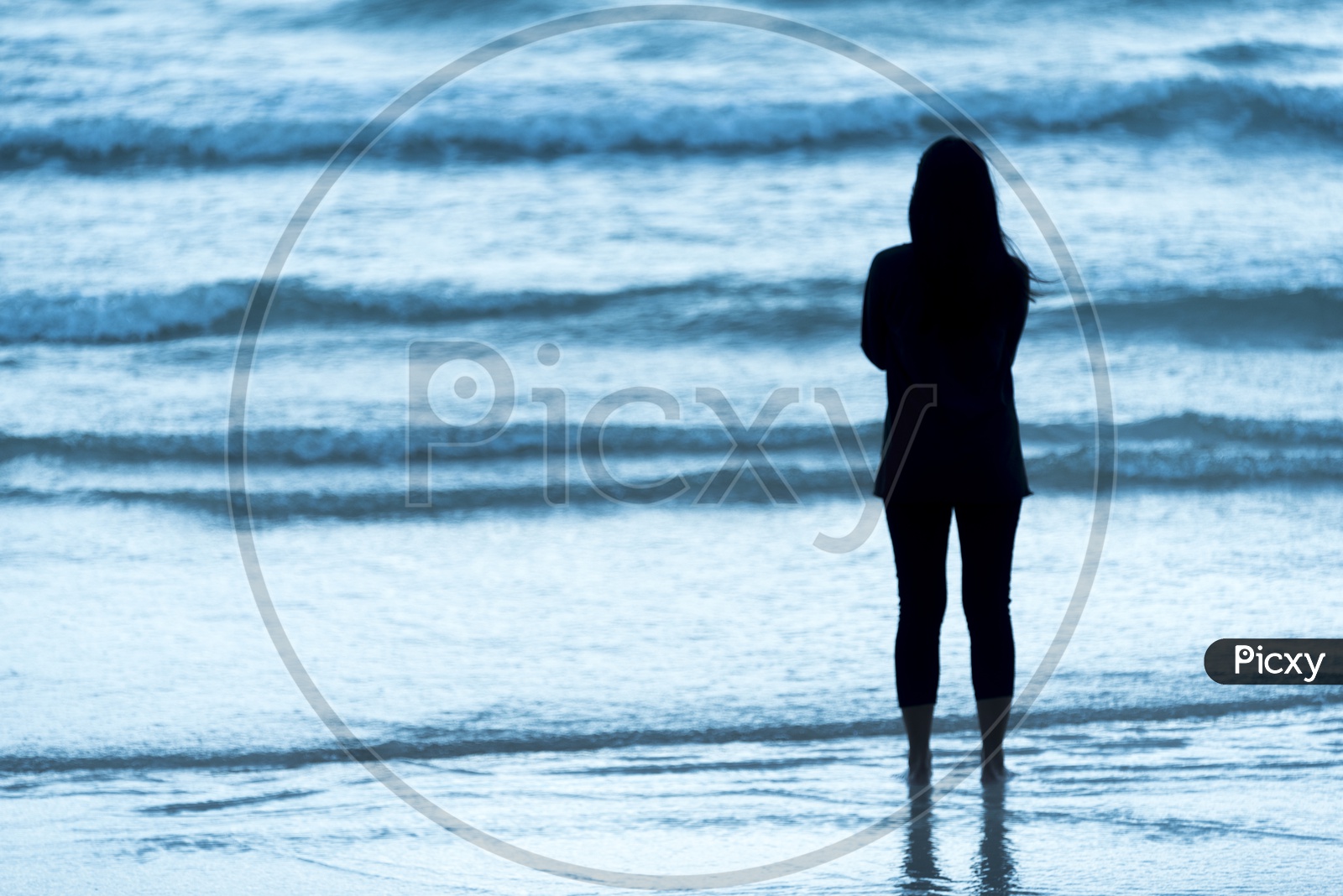 Silhouette Of An Lone Woman Standing at a Beach