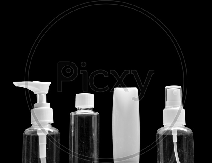 Empty cosmetic bottles isolated on black background