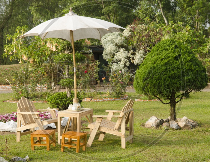 beautiful garden with flower and wooden table and chairs
