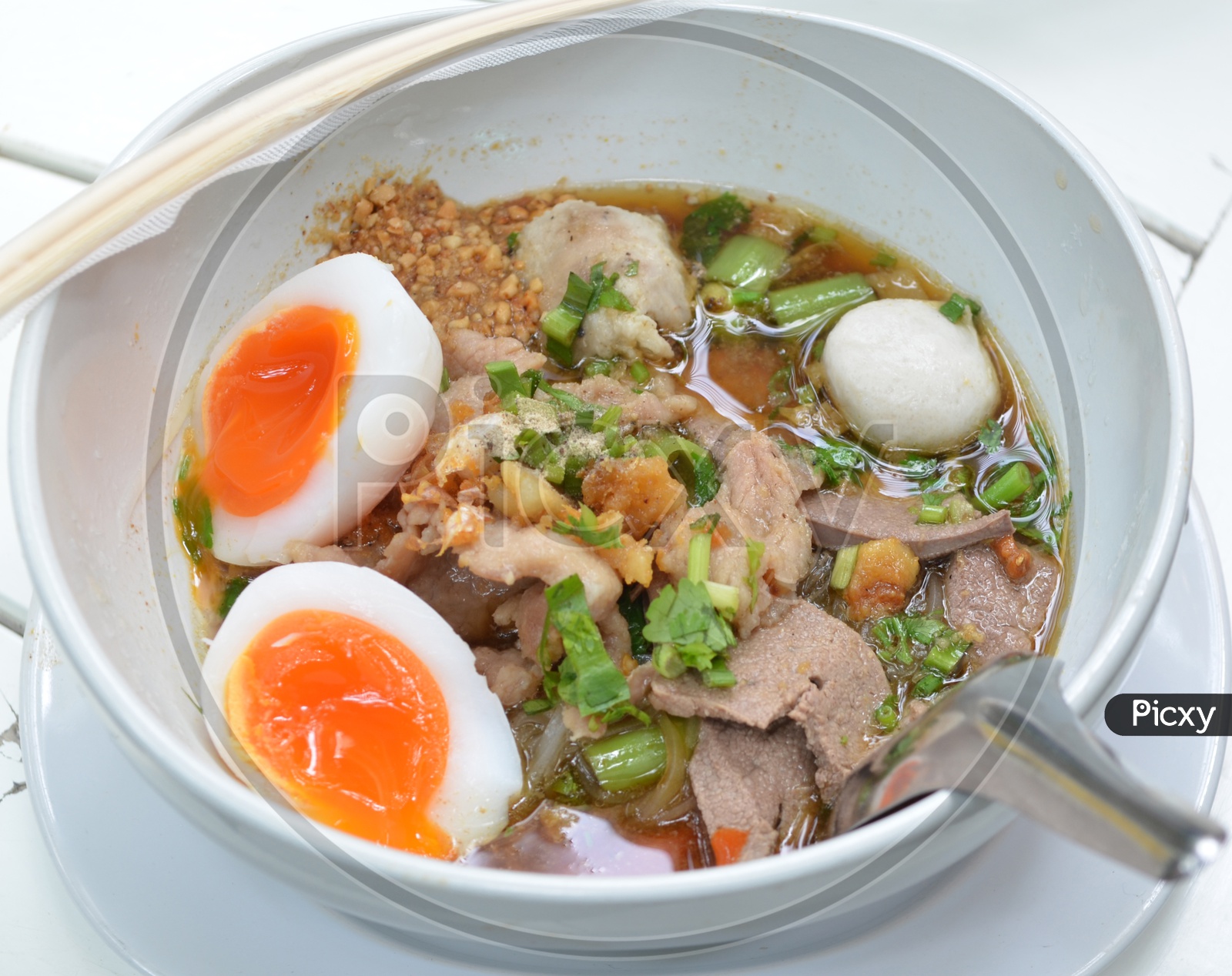 closeup of Bowl With Thai pork Noodles and  Boiled egg And Chop Sticks