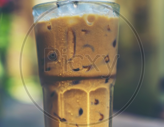 ice coffee glass on wooden table in cafe