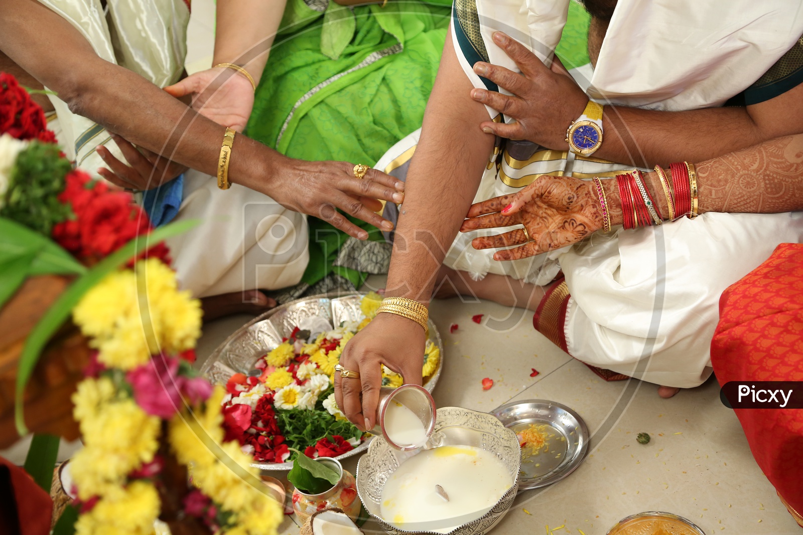 Indian Man pouring milk during pooja