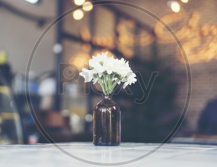 White Flowers in a Vase On a Cafe Table