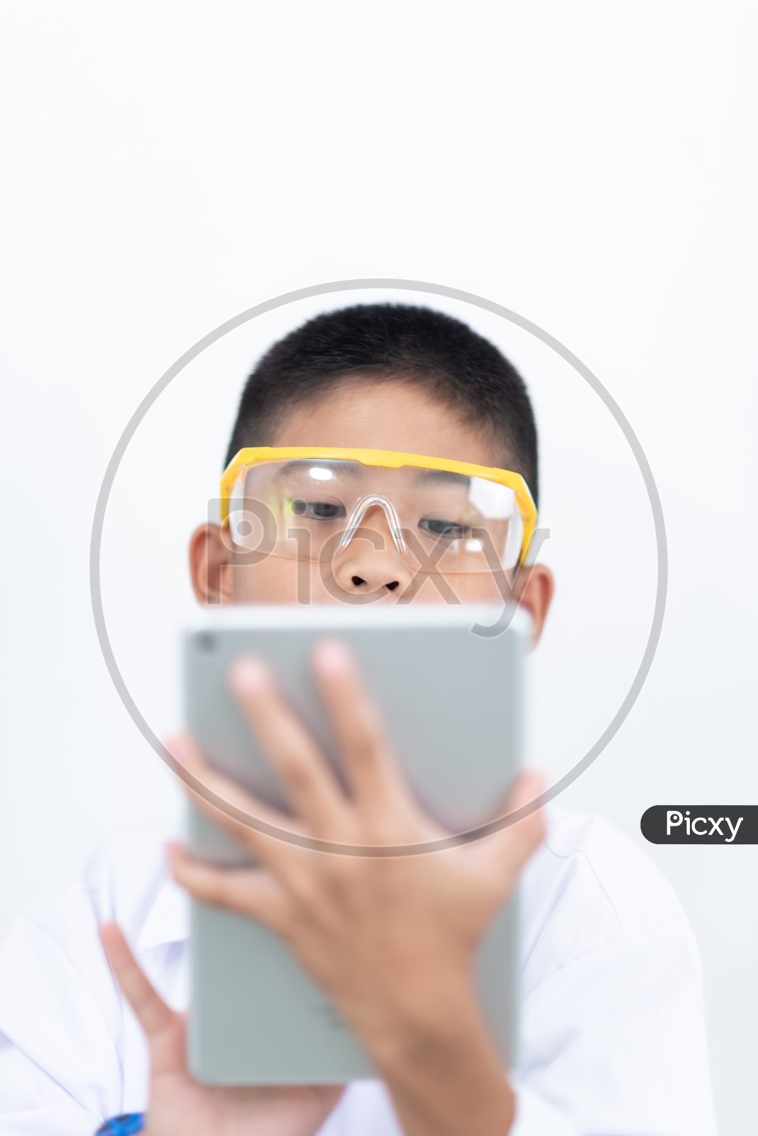 Curious boy Enjoying Learning In a Laboratory With IPAD
