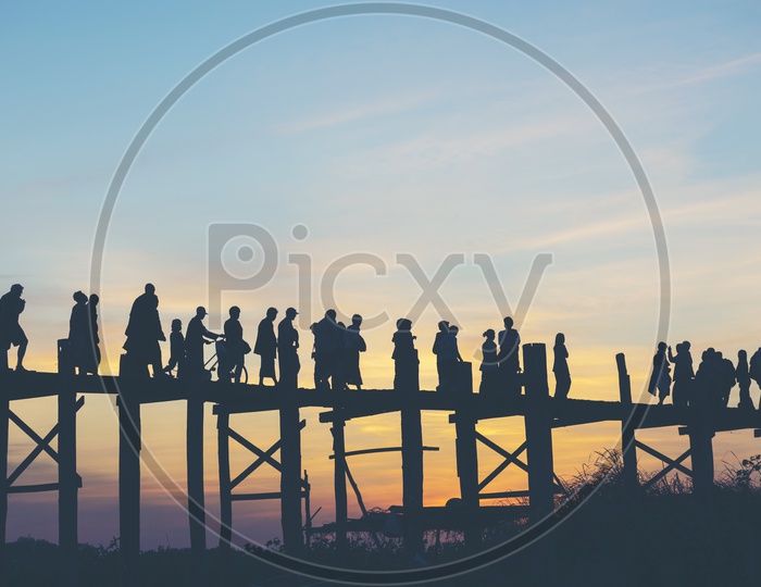 Silhouette of People at  U Beng Bridge or Wooden Bridge With Sunset Sky in Mandalay, Myanmar