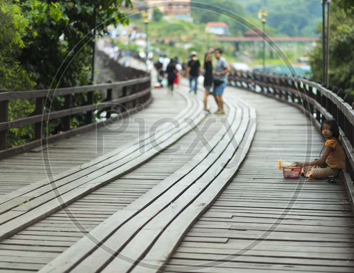 closeup unidentified Mon child at wooden bridge in Sangklaburi ,Thailand