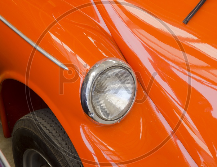 Head Light Of a Orange  Vintage Car