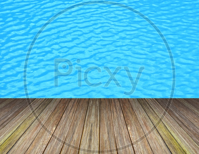 part of swimming pool with blue water and Wooden Plank Forming a background