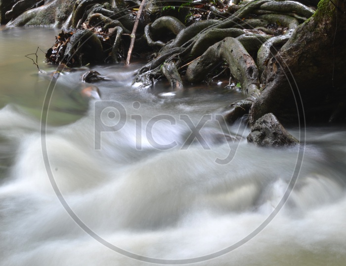 Water Flowing Over stones With Silky Texture Of Water Flow