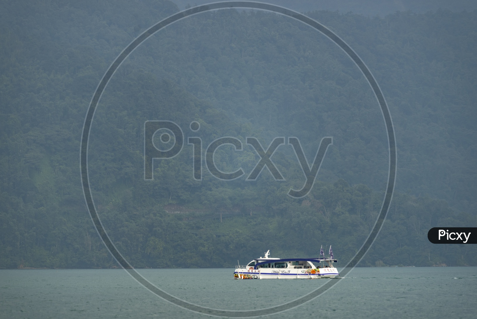 Tourist boats docking in peachful morning at Shuishe Pier, Sun Moon Lake, Taiwan.