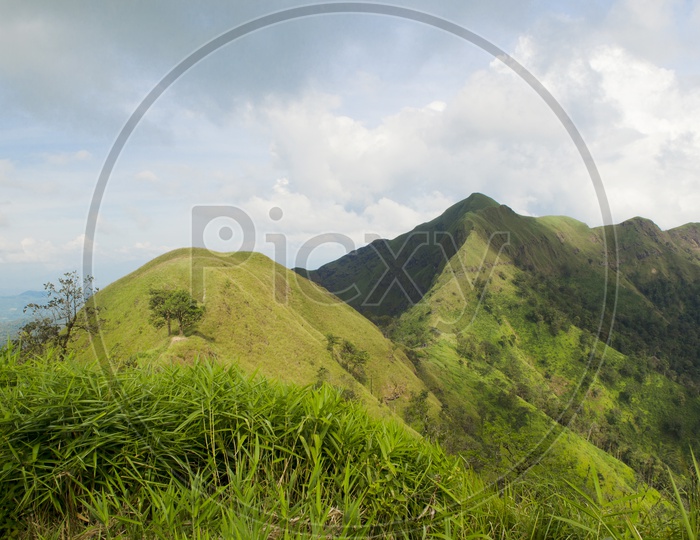 A Landscape With Green Mountains Peaks And Sky With Cotton Clouds at Khao Chang Phueak Pilok
