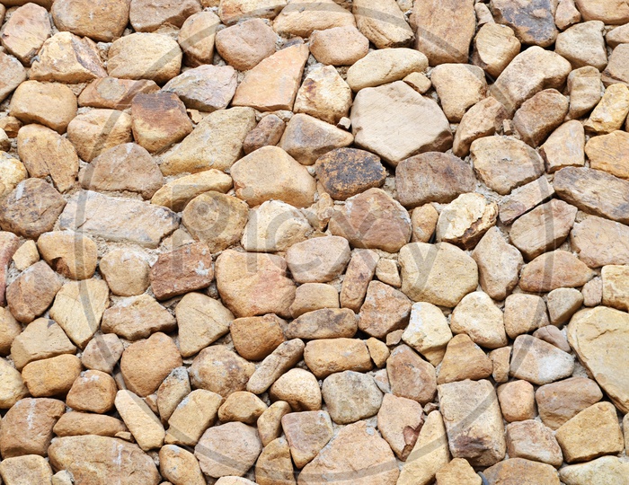 Stone Wall Closeup With Patterns on Wall By Stones Forming a background
