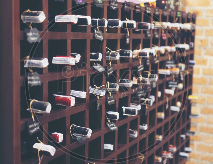 wine bottles stacked on wooden racks in cellar Closeup Forming a Background