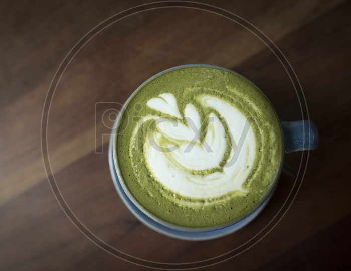 Latte Of Matcha Green Tea  On a Cafe Table  Background