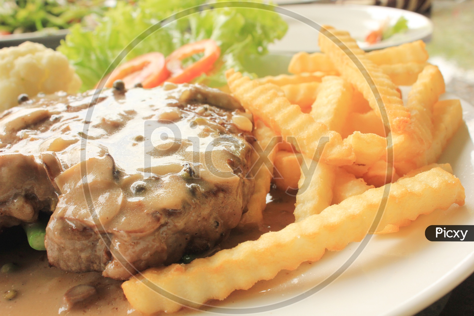 Grilled Beef steak with French Fries in a Plate