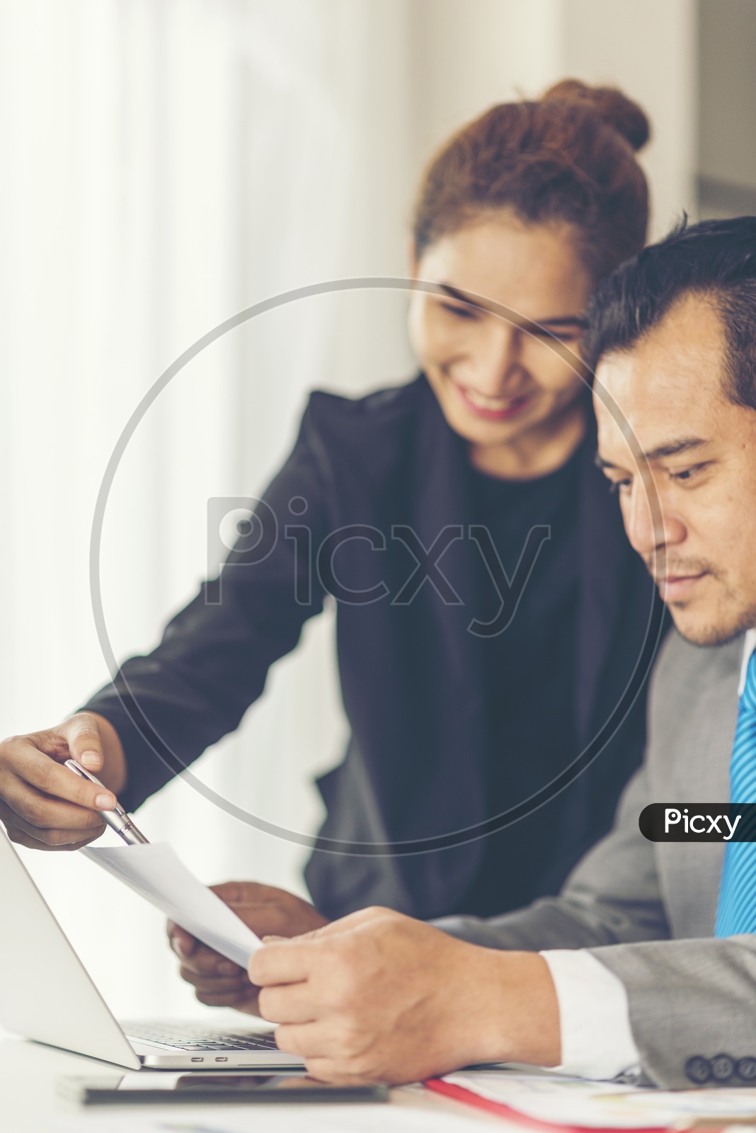 Employees Discussing Business Plans or Progress in Office Desk Background