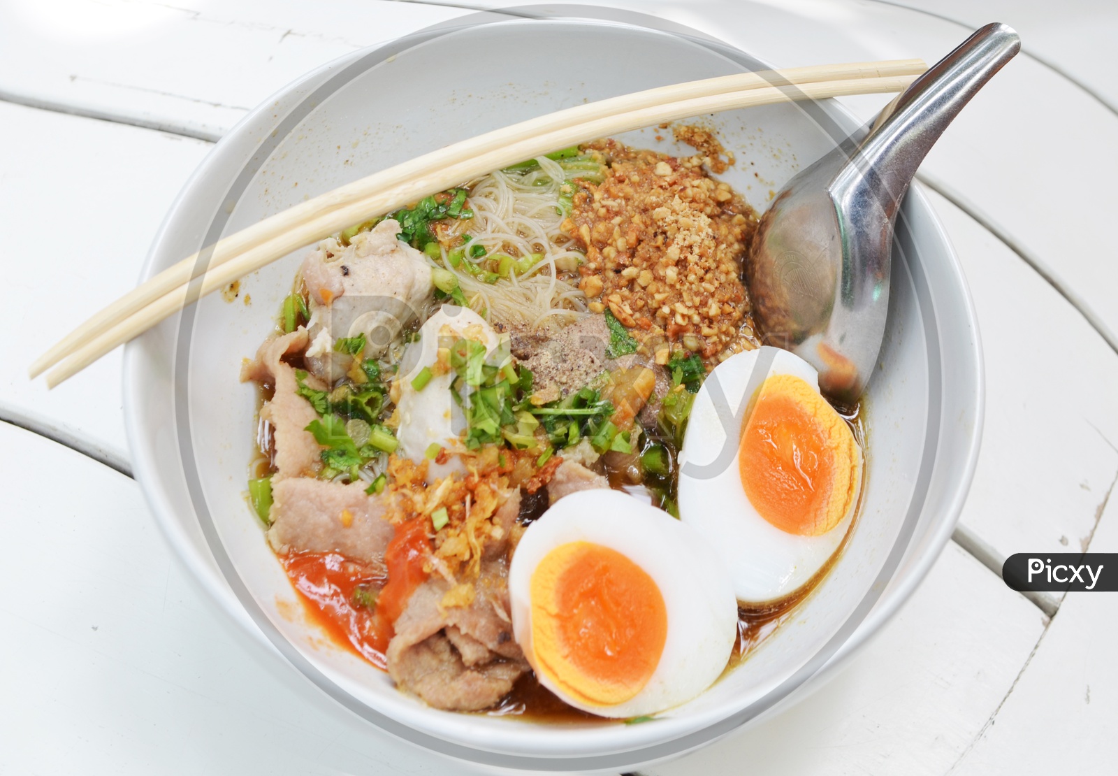 Bowl With Thai pork Noodles and  Boiled egg And Chop Sticks