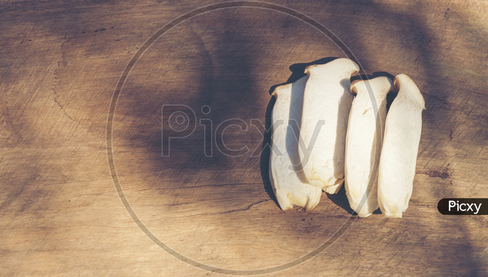 Processed sliced mushrooms on a wooden background