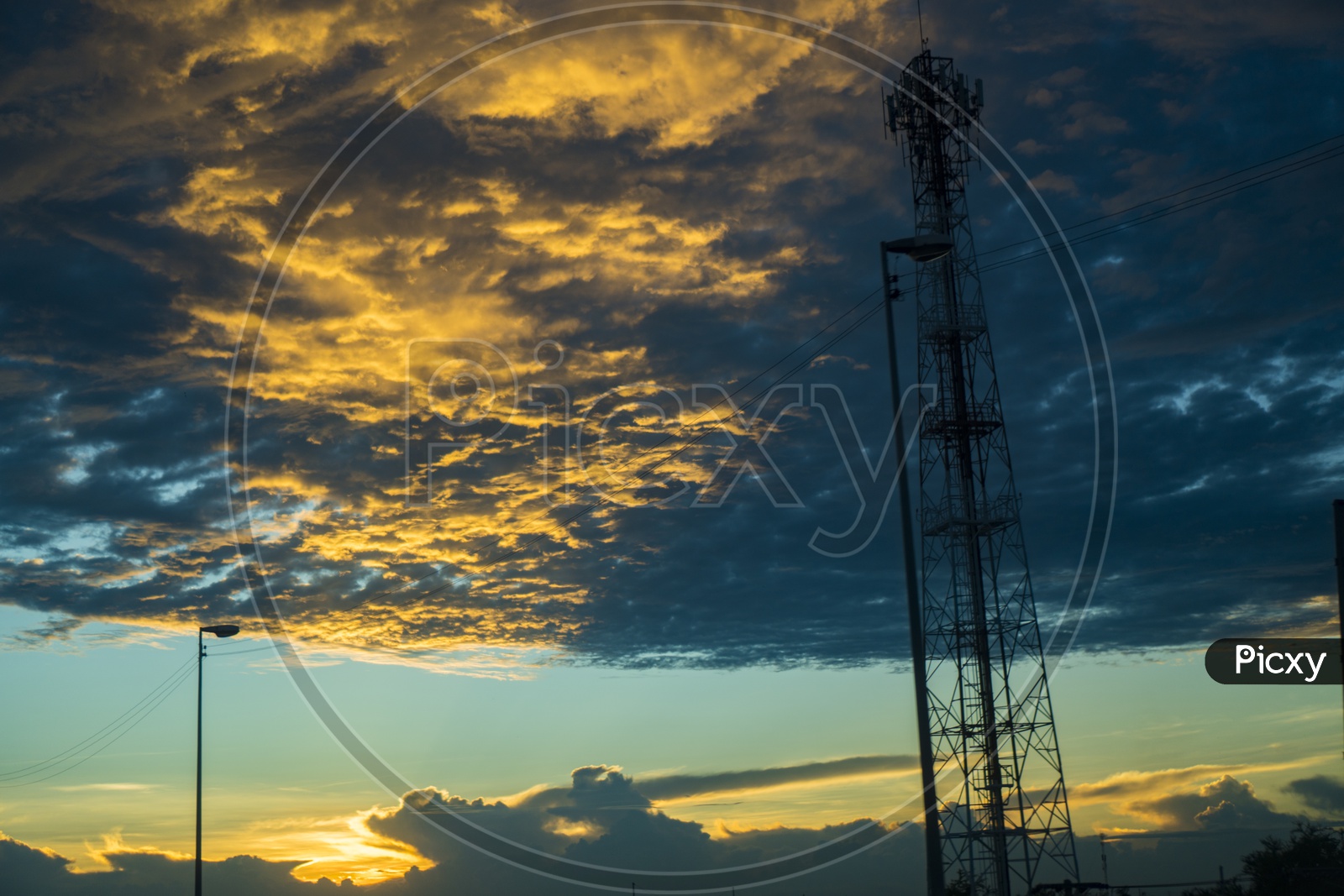 Silhouette of Tele network Tower Over a Sunset Sky