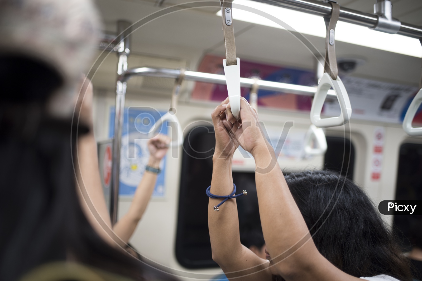 Commuters Hands Holding Support Handle bars in train