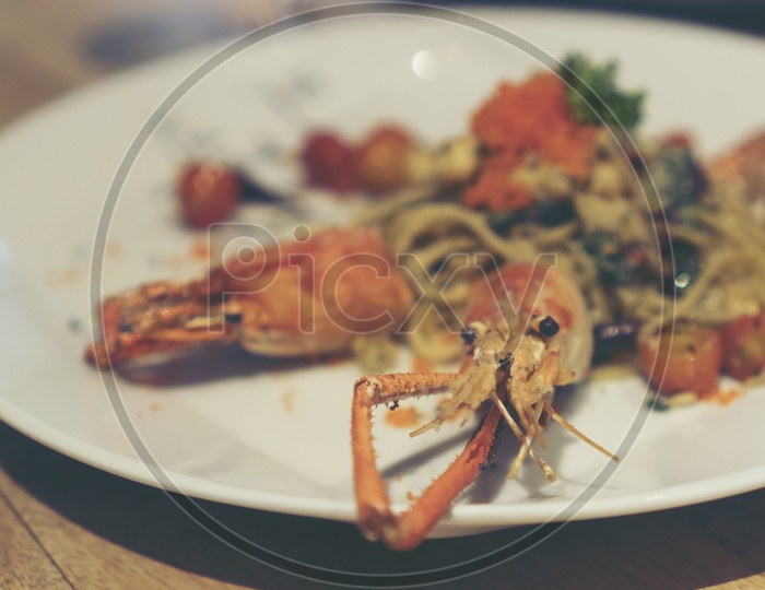 Spaghetti with shrimp and herbs on a  Restaurant Plate Closeup